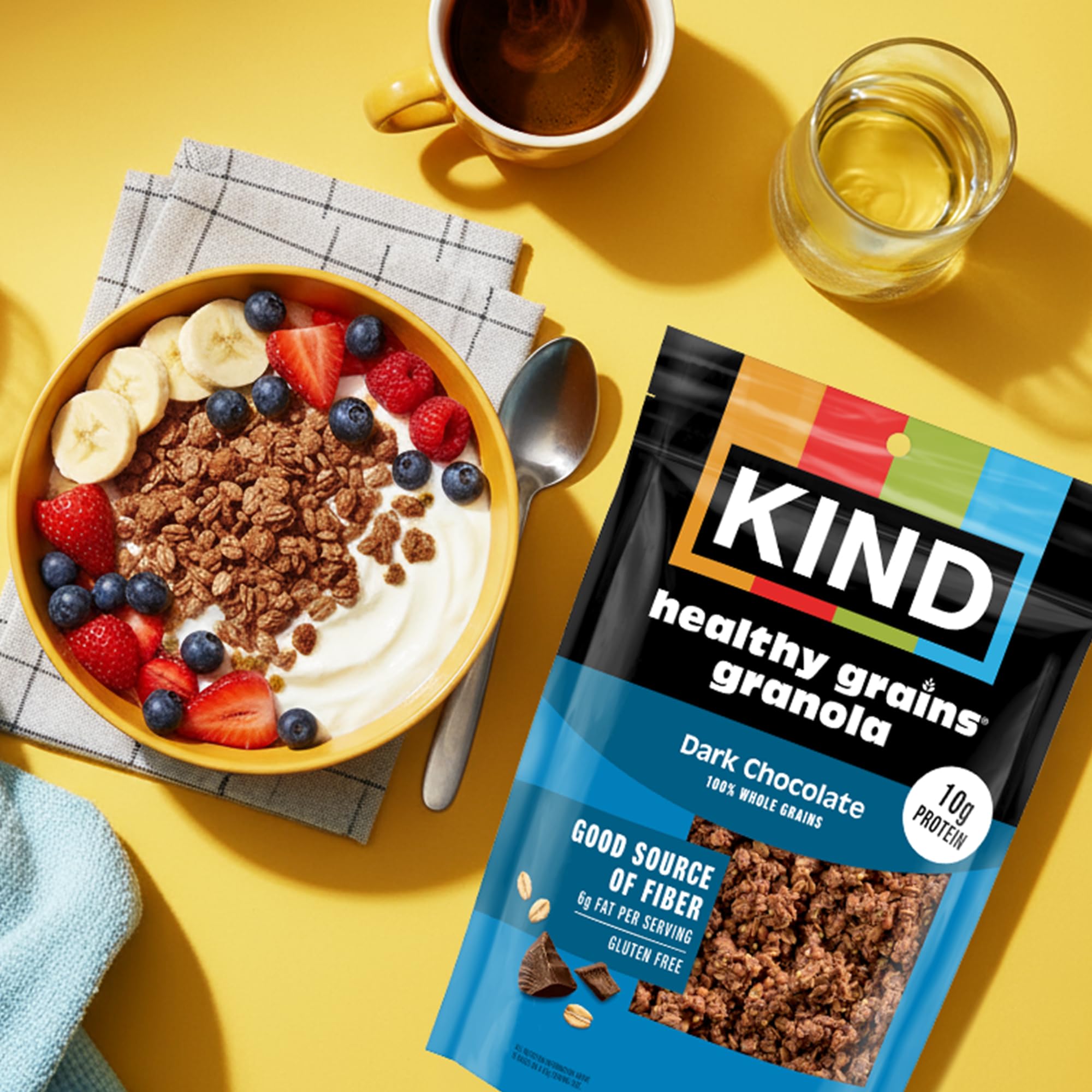 Three 11oz KIND granola pouches on a kitchen shelf