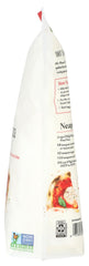 Dough being stretched to reveal leopard spots and blistered rim with King Arthur flour.