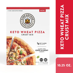 Close-up of a baked King Arthur Keto Pizza Crust topped with cheese and toppings.