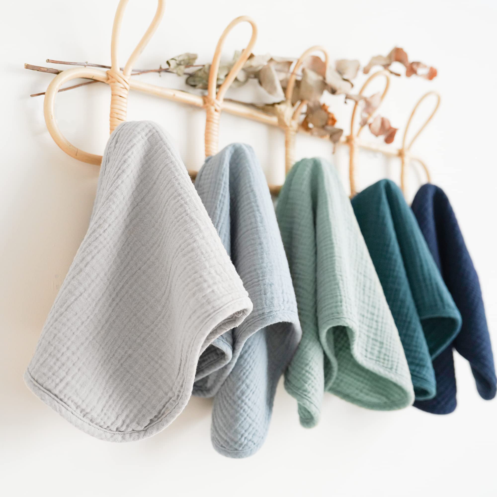 Konssy burp cloths in crib scene emphasizing generous size