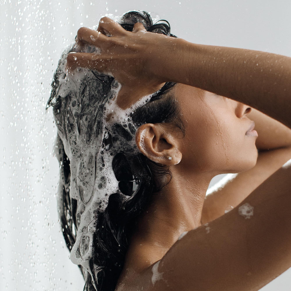 Kristin Ess Clarifying Shampoo lather close-up demonstrating cleansing action