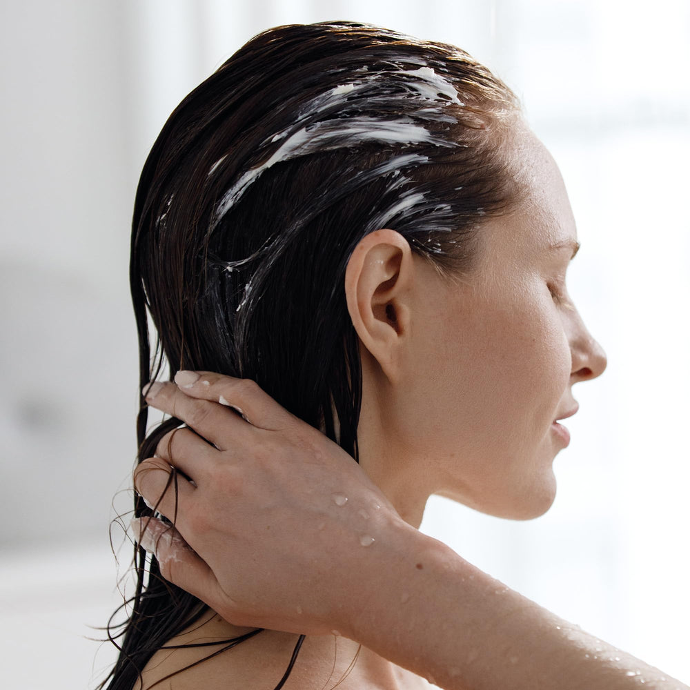 Kristin Ess Signature Conditioner dispenser bottle shown for easy application
