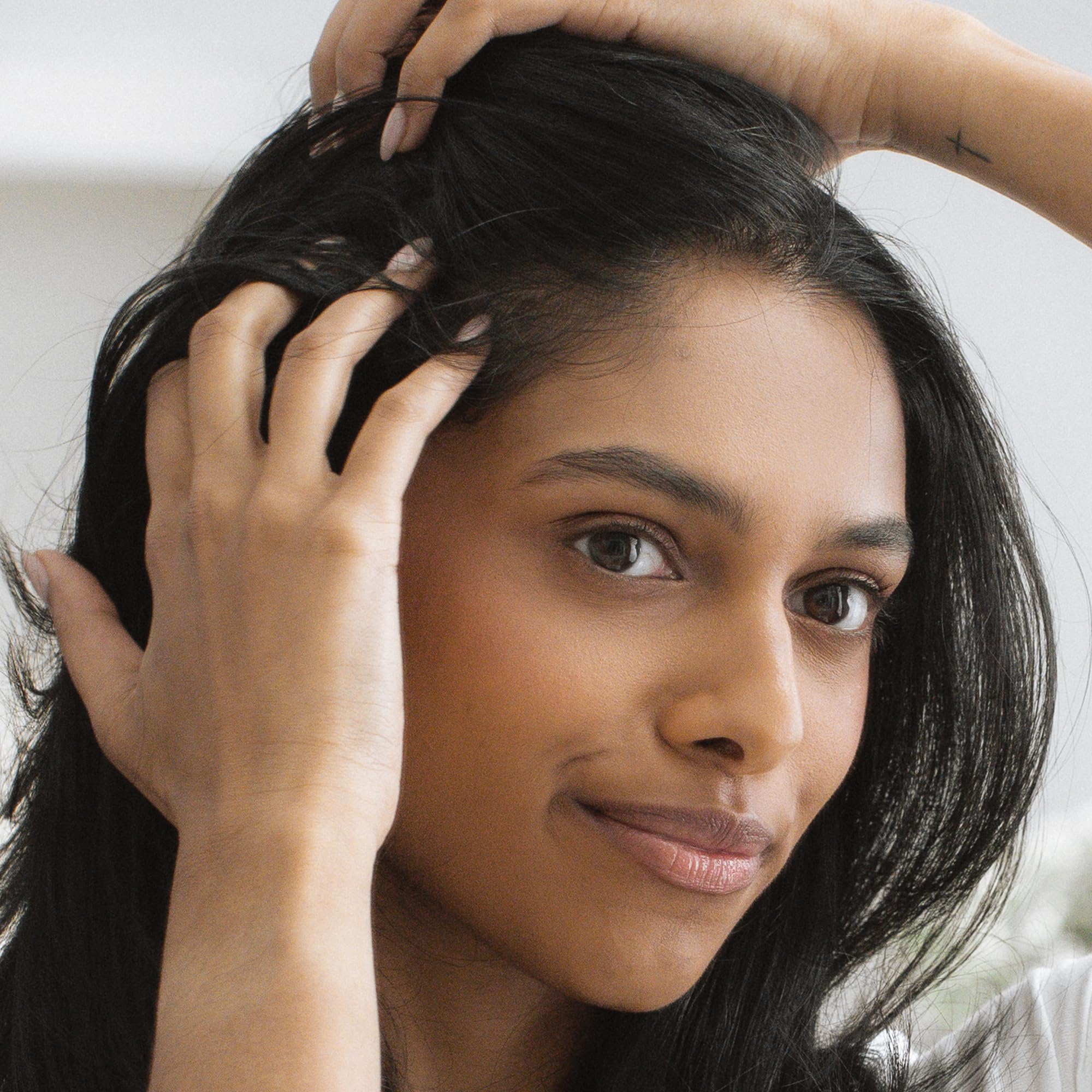 Kristin Ess vegan, lightweight powder blends invisibly into hair