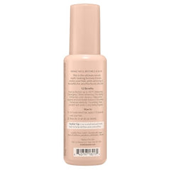 Kristin Ess leave-in spray being applied to hair during styling.