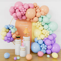 KUULBELA pastel rainbow arch kit showing three balloon sizes for a dramatic centerpiece