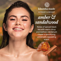 Kuumba Made Amber & Sandalwood product label close-up highlighting vegan formula.