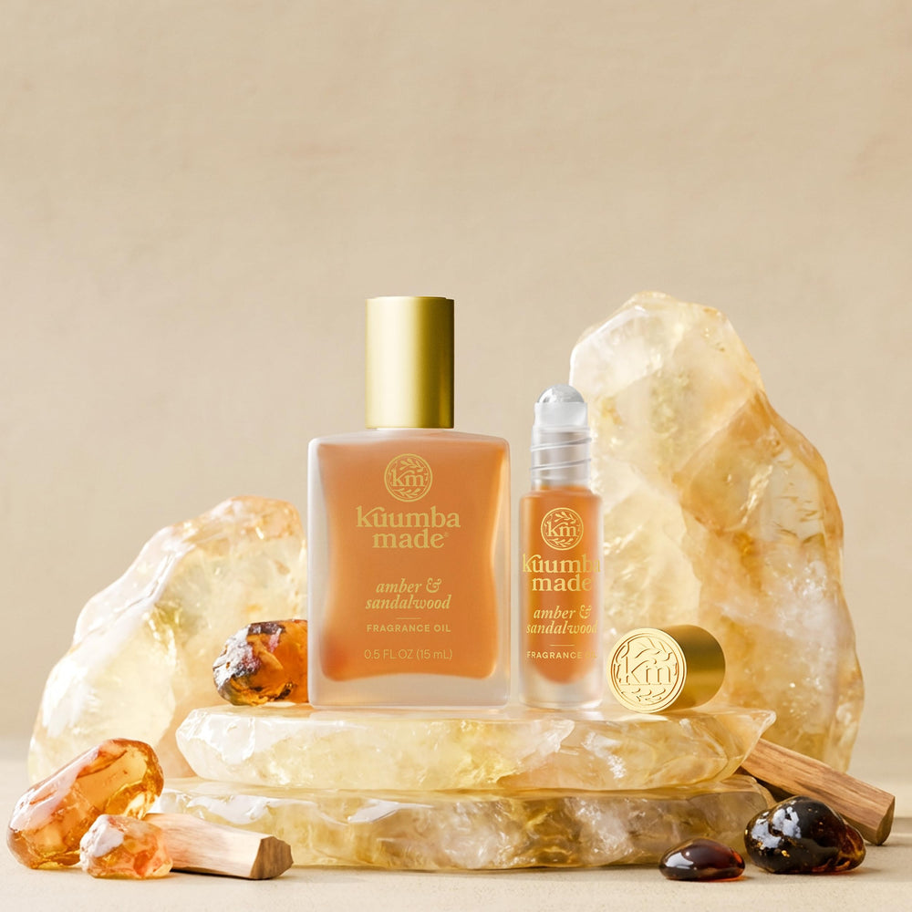 Kuumba Made Amber & Sandalwood vegan cruelty-free emblem and packaging emphasis.