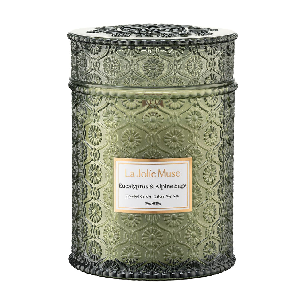 LA JOLIE MUSE eucalyptus-alpine-sage candle in a daisy-embossed jar adds elegant ambiance