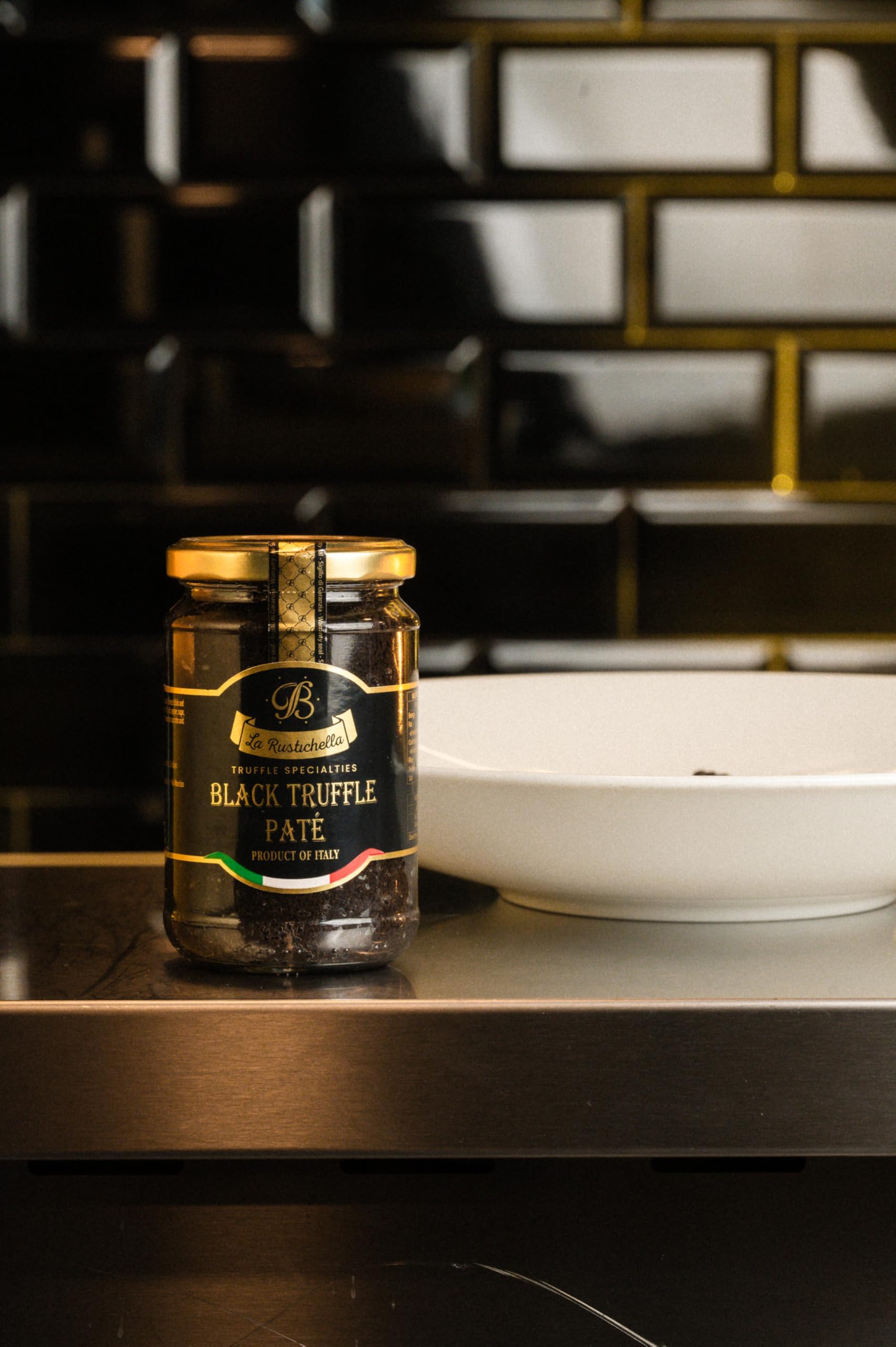 La Rustichella Black Truffle Pate open jar with spoon for quick gourmet snacking.