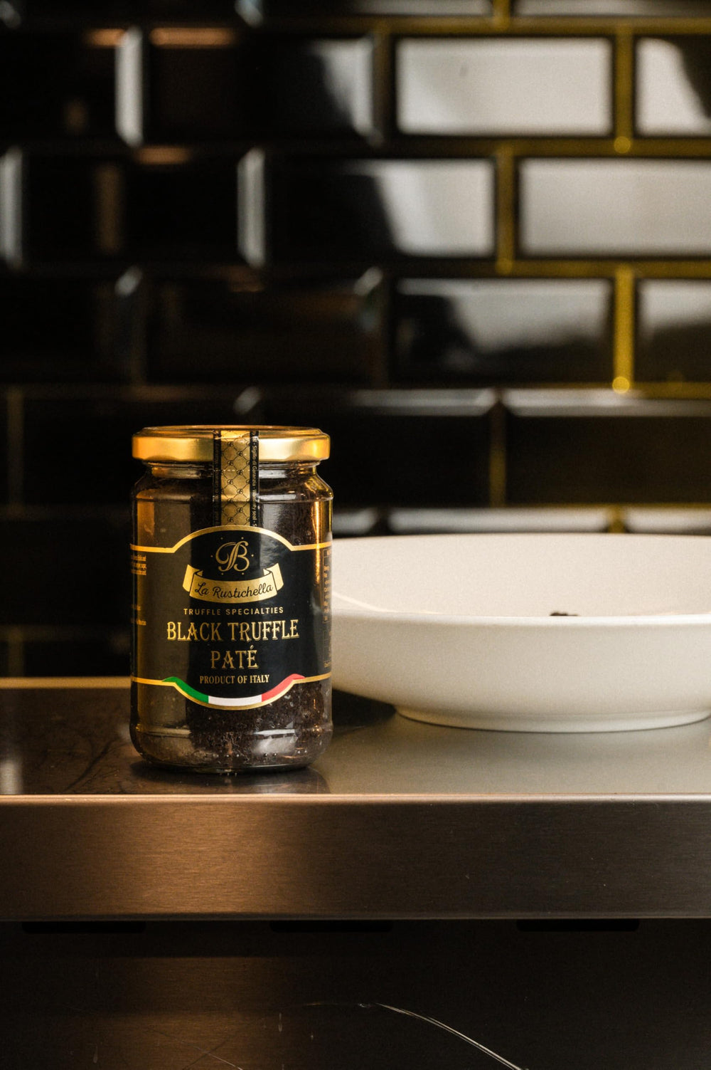 La Rustichella Black Truffle Pate open jar with spoon for quick gourmet snacking.