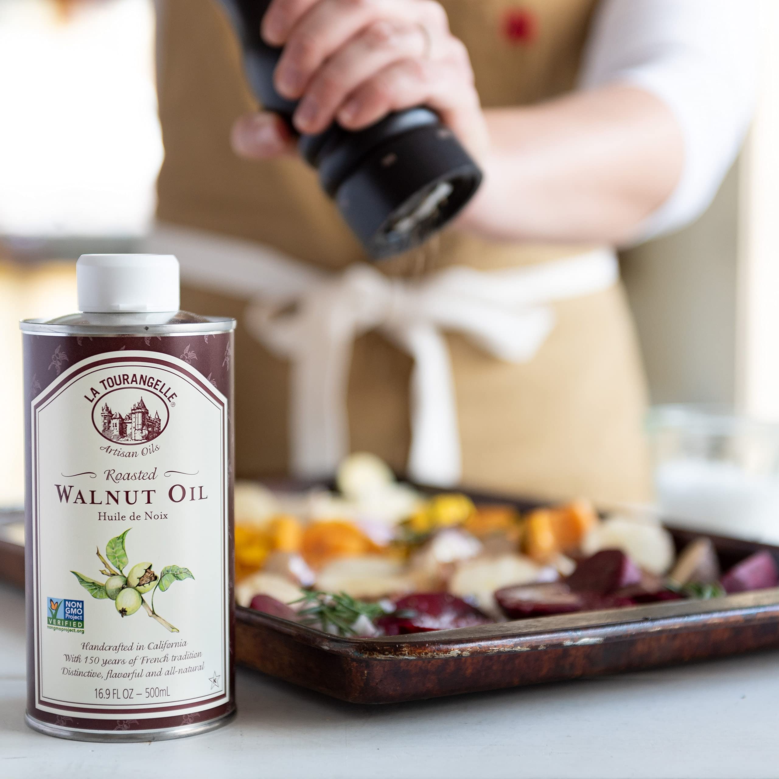 La Tourangelle Roasted Walnut Oil pouring into skillet for light sauté.