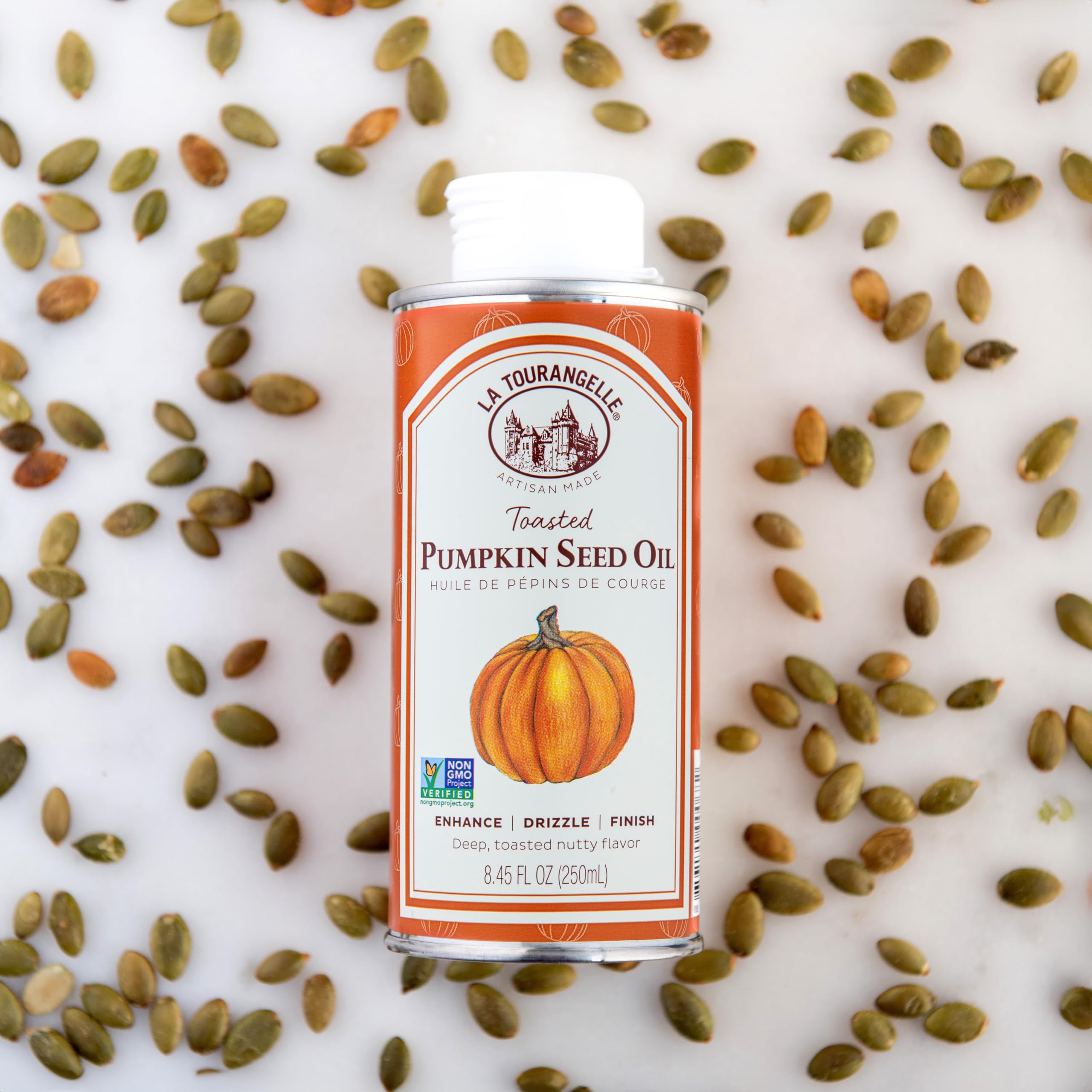 La Tourangelle Toasted Pumpkin Seed Oil on a busy kitchen counter with ingredients