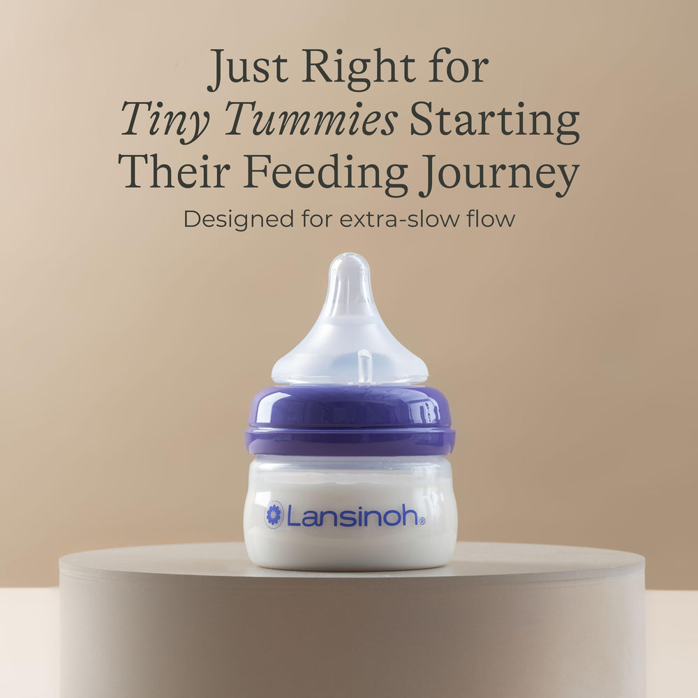 Baby feeding with Lansinoh bottle demonstrates easy breast-to-bottle transitions.