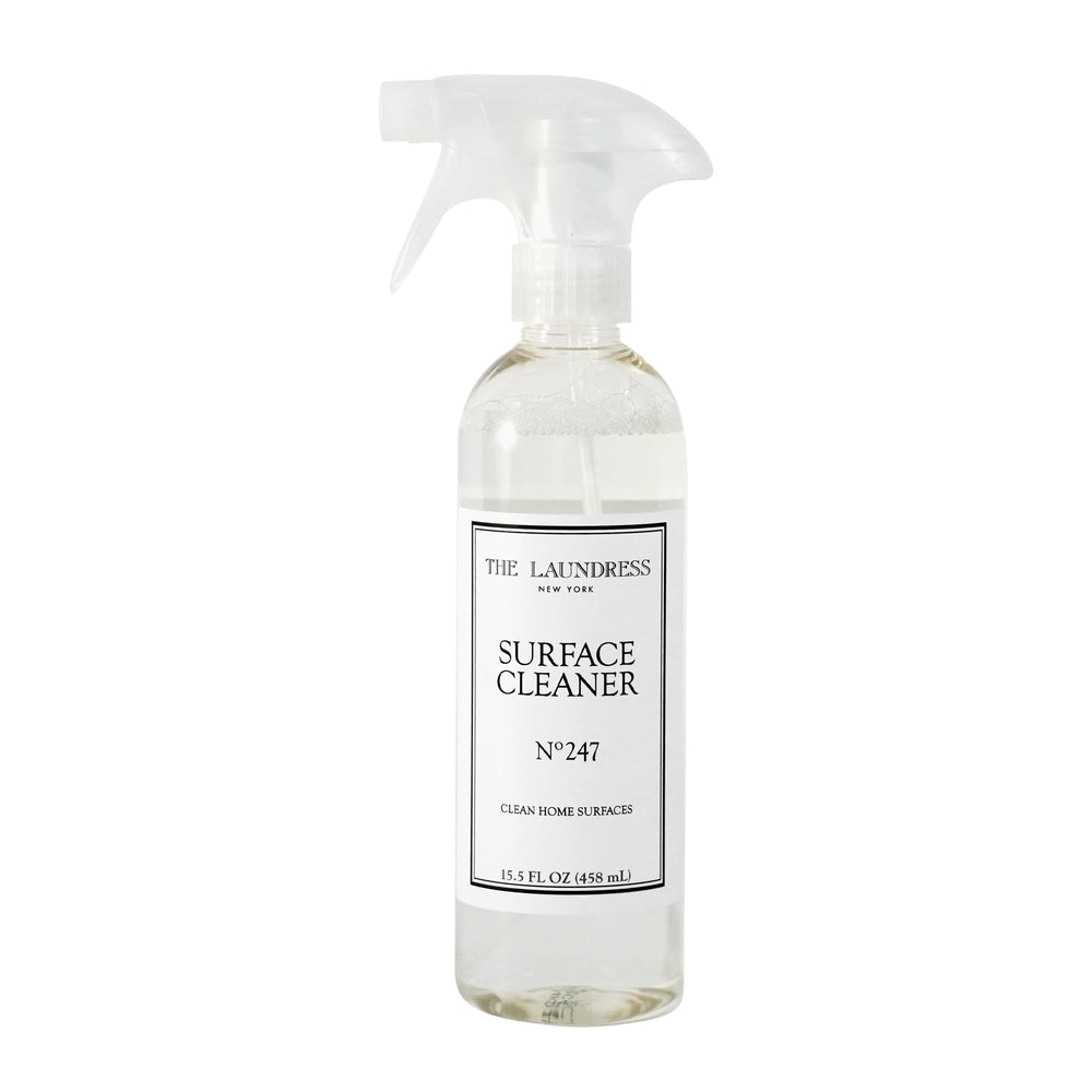 The Laundress Surface Cleaner No. 247 bottle pour enabling controlled, streak-free cleaning.