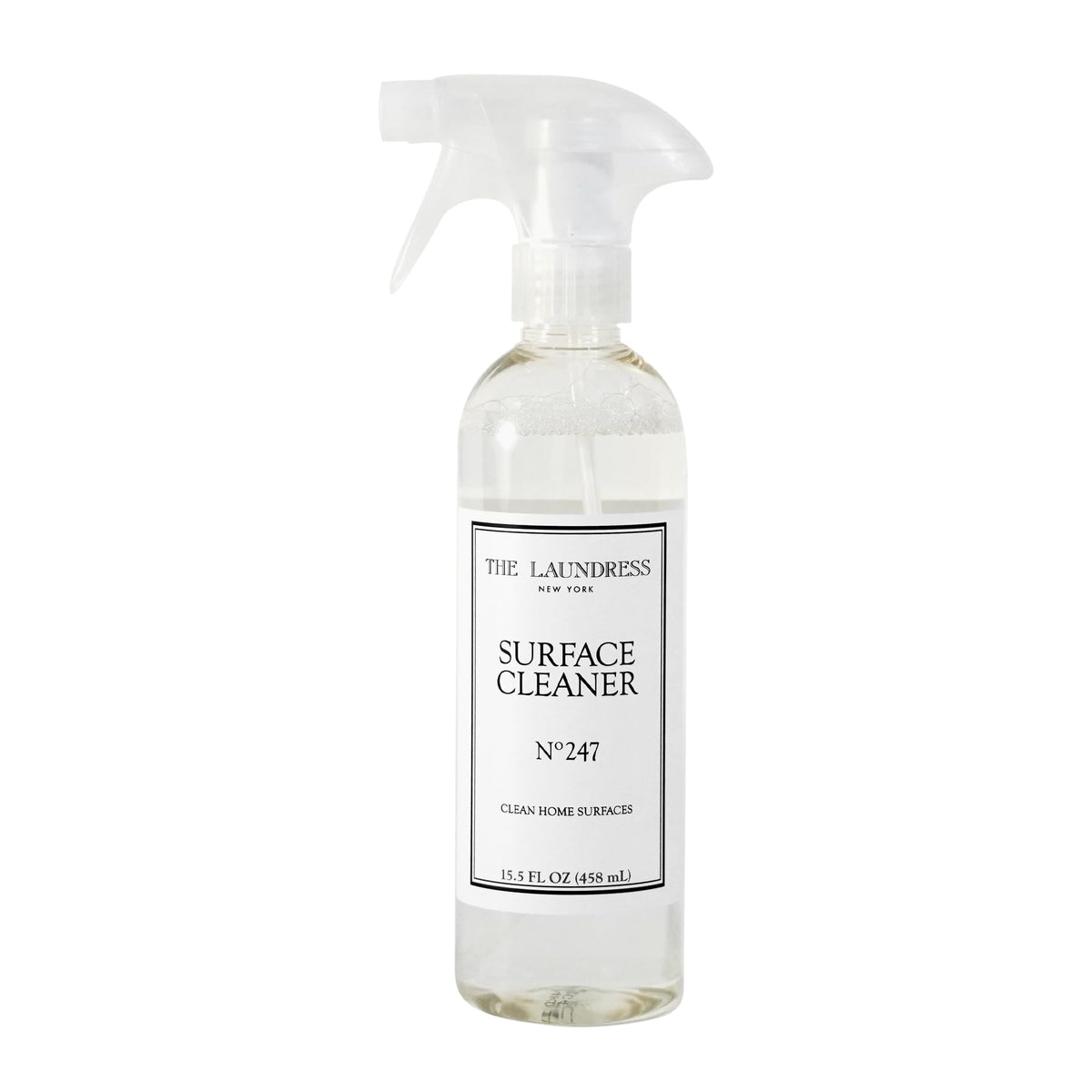 The Laundress Surface Cleaner No. 247 bottle pour enabling controlled, streak-free cleaning.