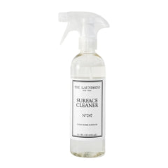 The Laundress Surface Cleaner No. 247 bottle pour enabling controlled, streak-free cleaning.