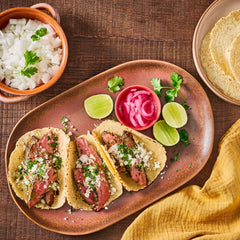 Lawry's Casero Total Seasoning on grilled meats releasing rich aroma
