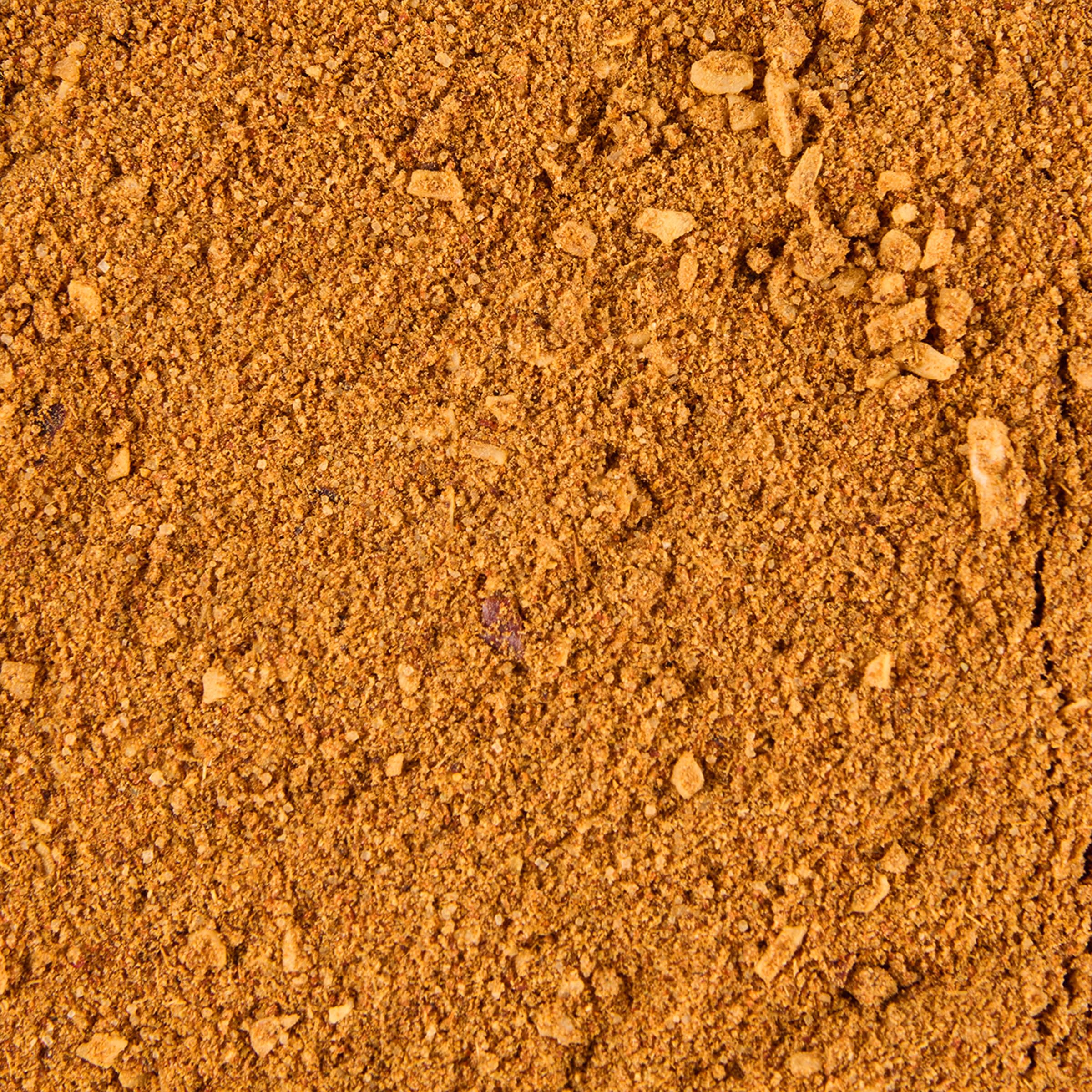 Lawry's taco seasoning closeup with tortilla chips ready to dip