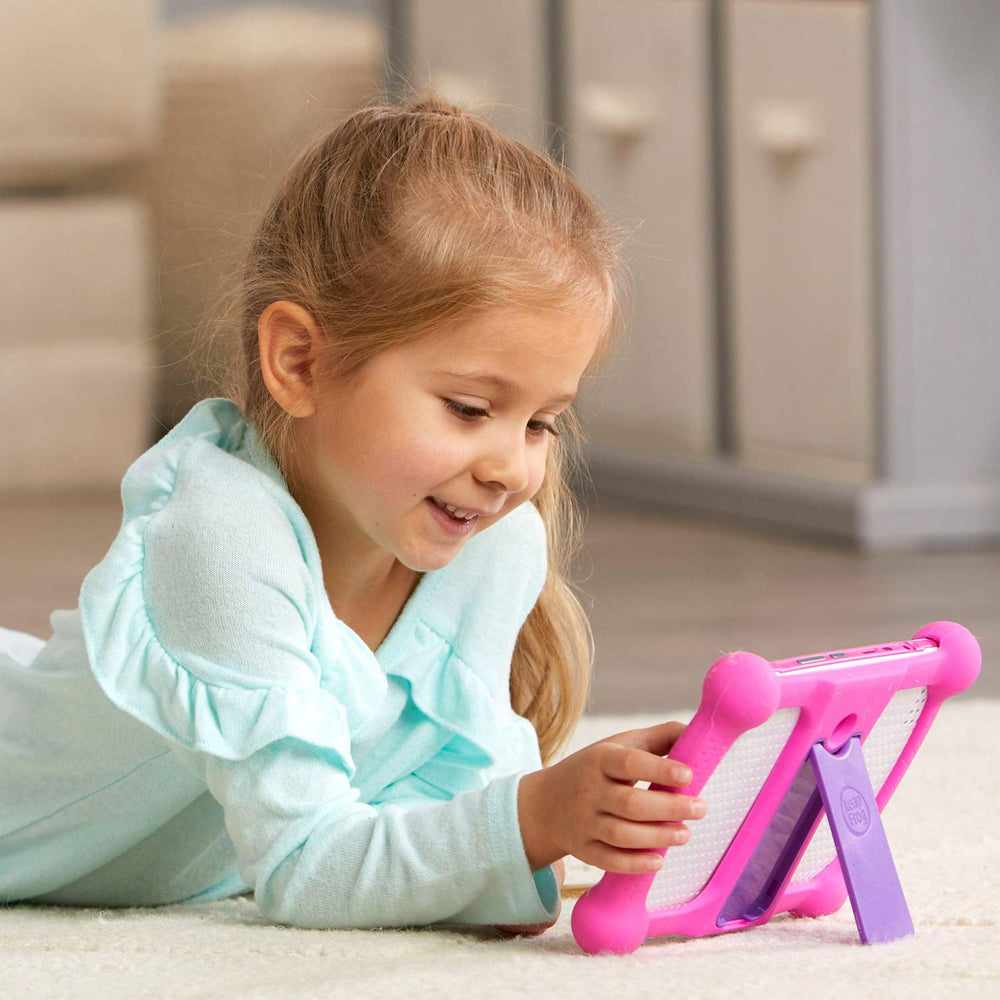 Child using LeapPad Academy pink tablet for learning activities