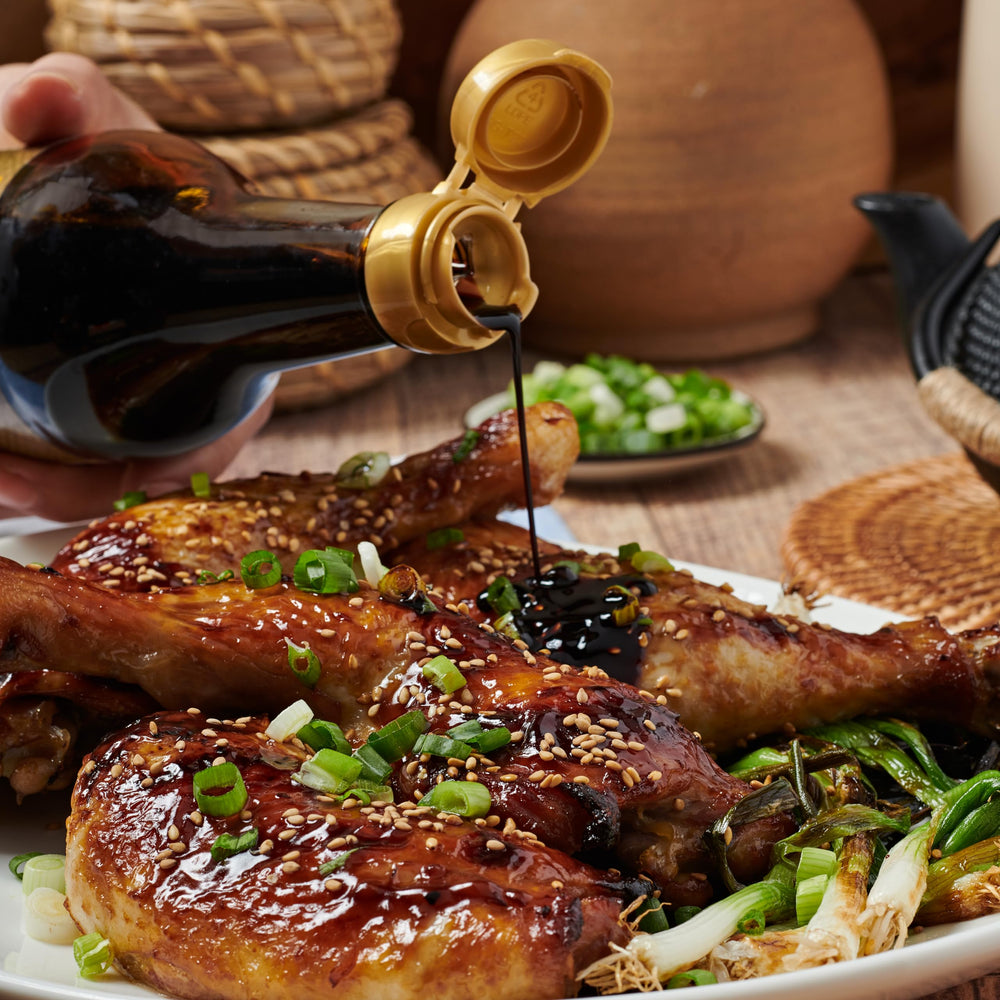 Lee Kum Kee Premium Dark Soy Sauce bottle highlights natural color in dishes.