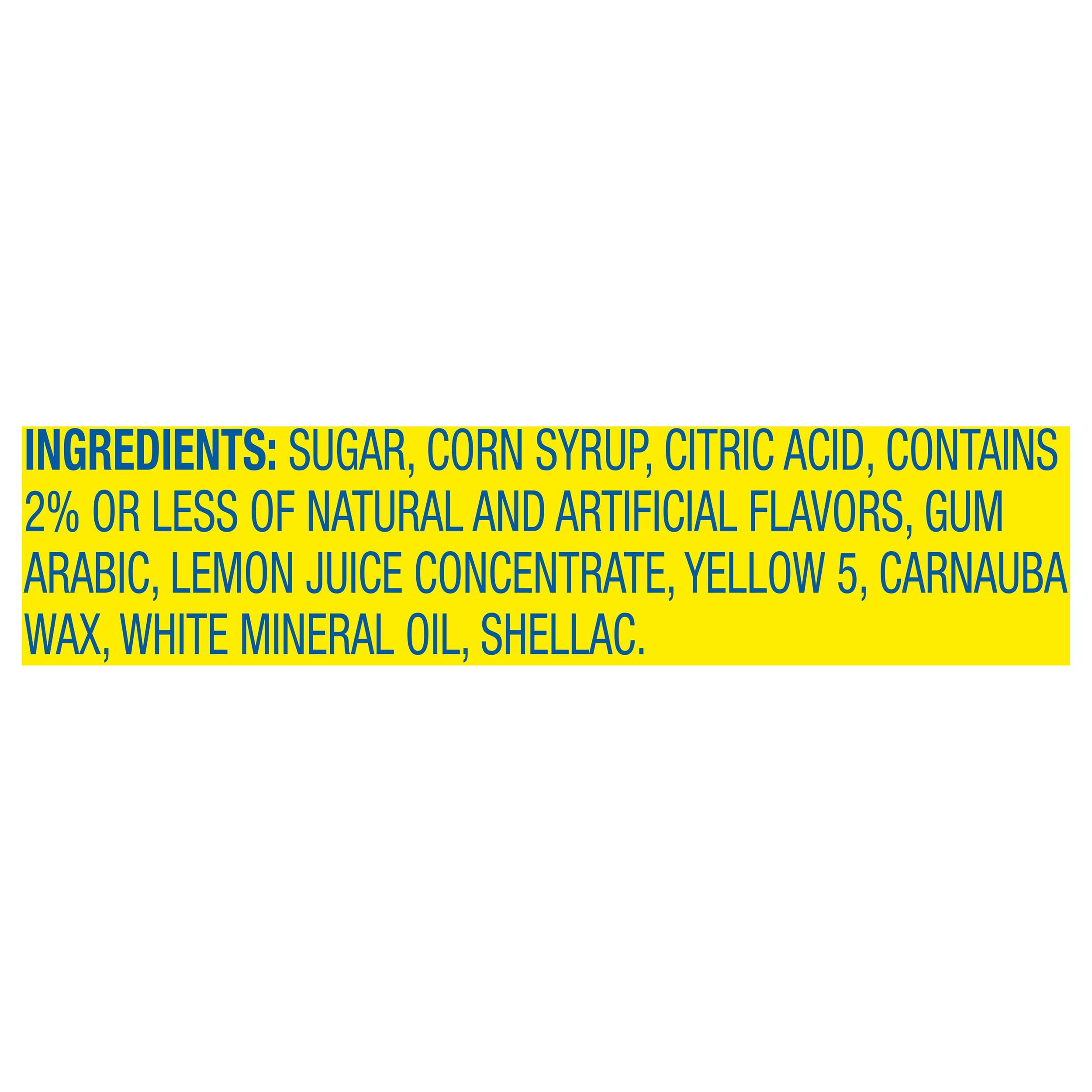Close-up of Lemonhead candy texture showing crisp tangy bite