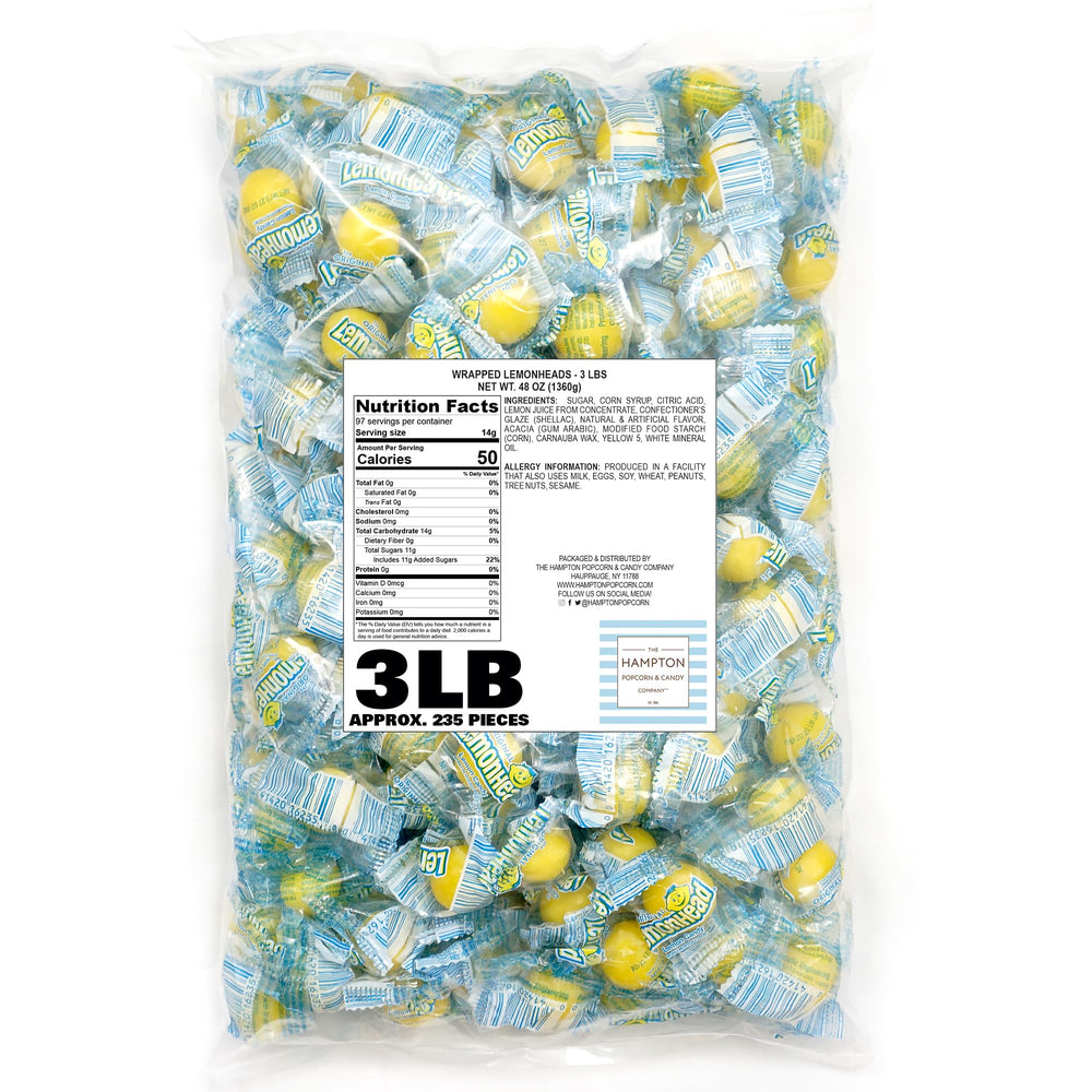 Lemonheads hard candy close-up shows bright yellow tangy shell.