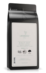 LIFEBOOST Half Caff ground coffee cup foreground delivering smooth morning energy.