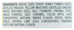 Lillie's Q Honey Barbeque Sauce on chicken wings for flavorful coating.