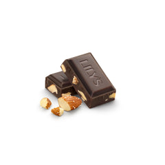 LILY'S Salted Almond Extra Dark Bar being broken to reveal almonds and chocolate