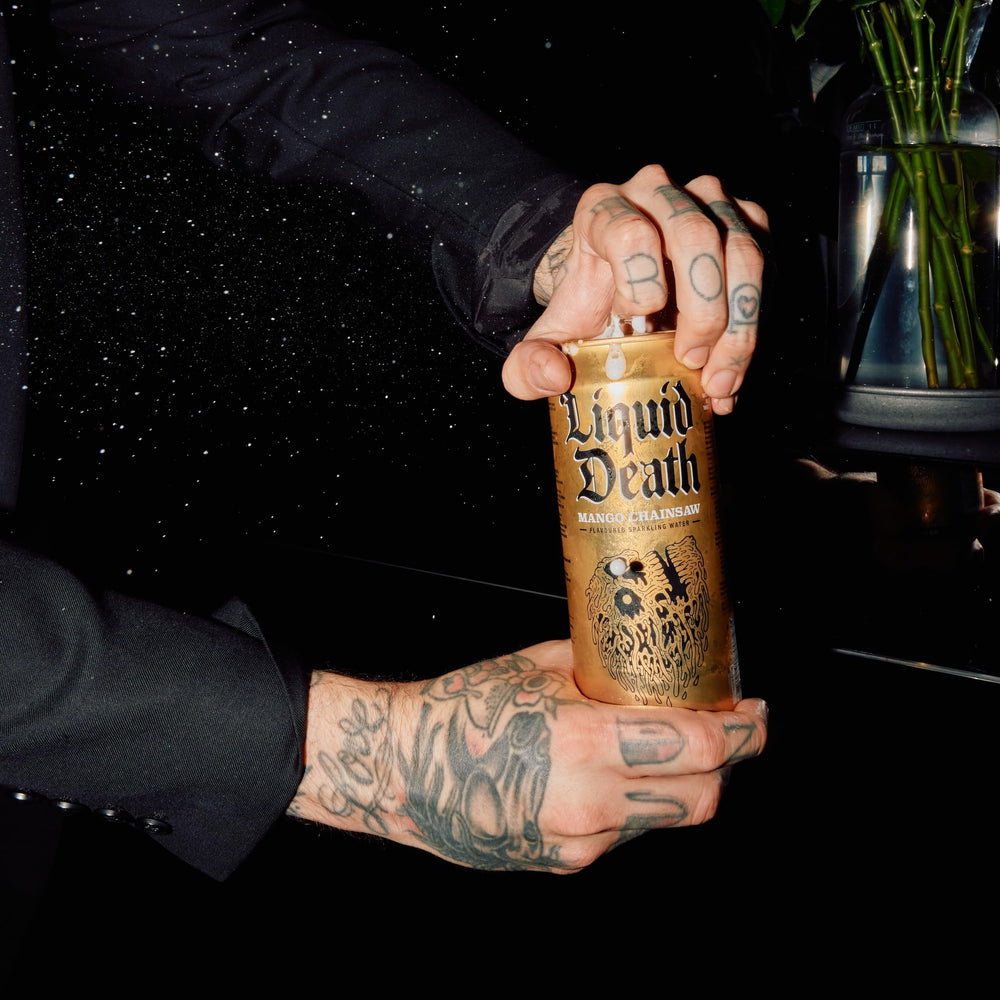 Liquid Death Mango Chainsaw can with meals provides refreshing mango notes.