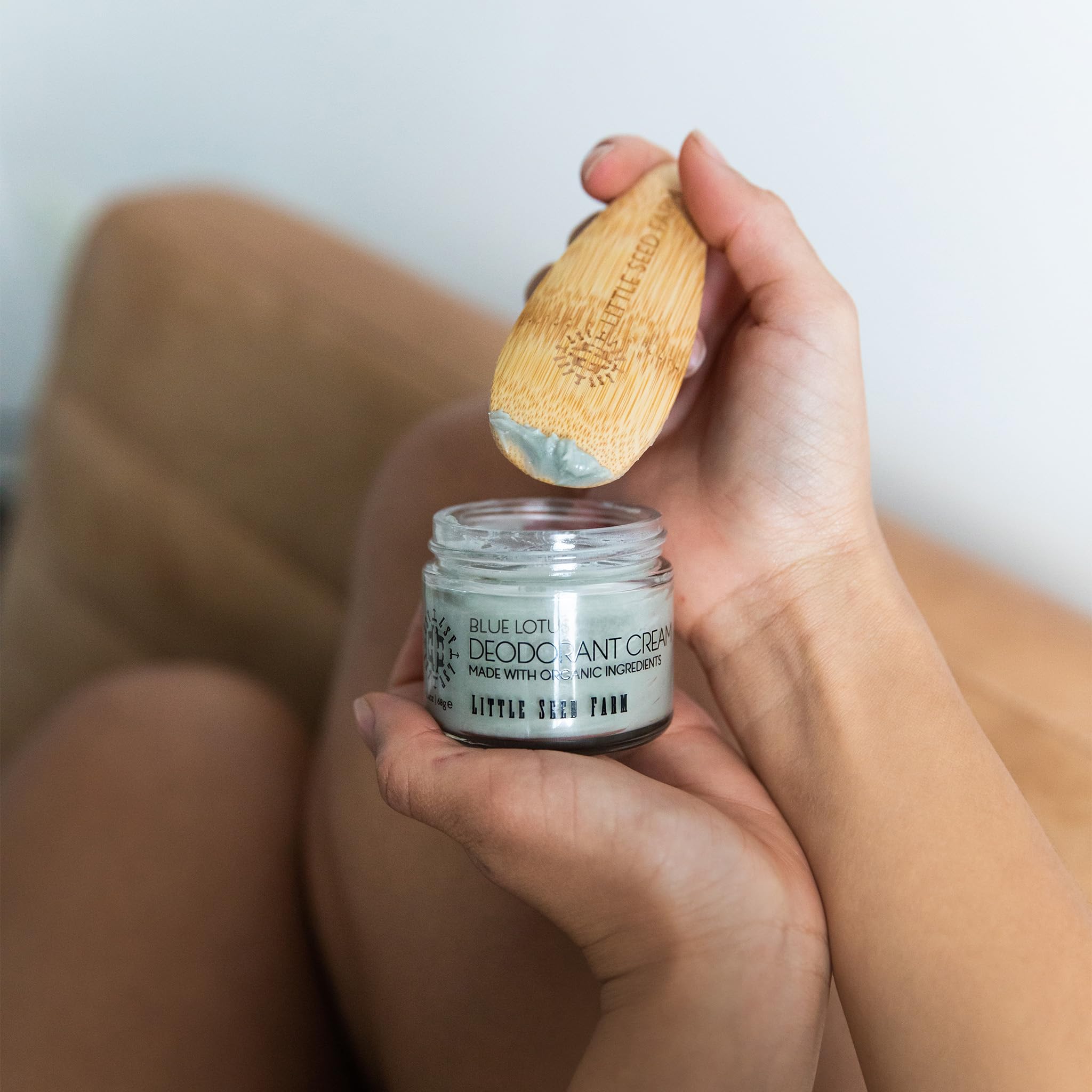 Applying Little Seed Farm Blue Lotus deodorant in hand