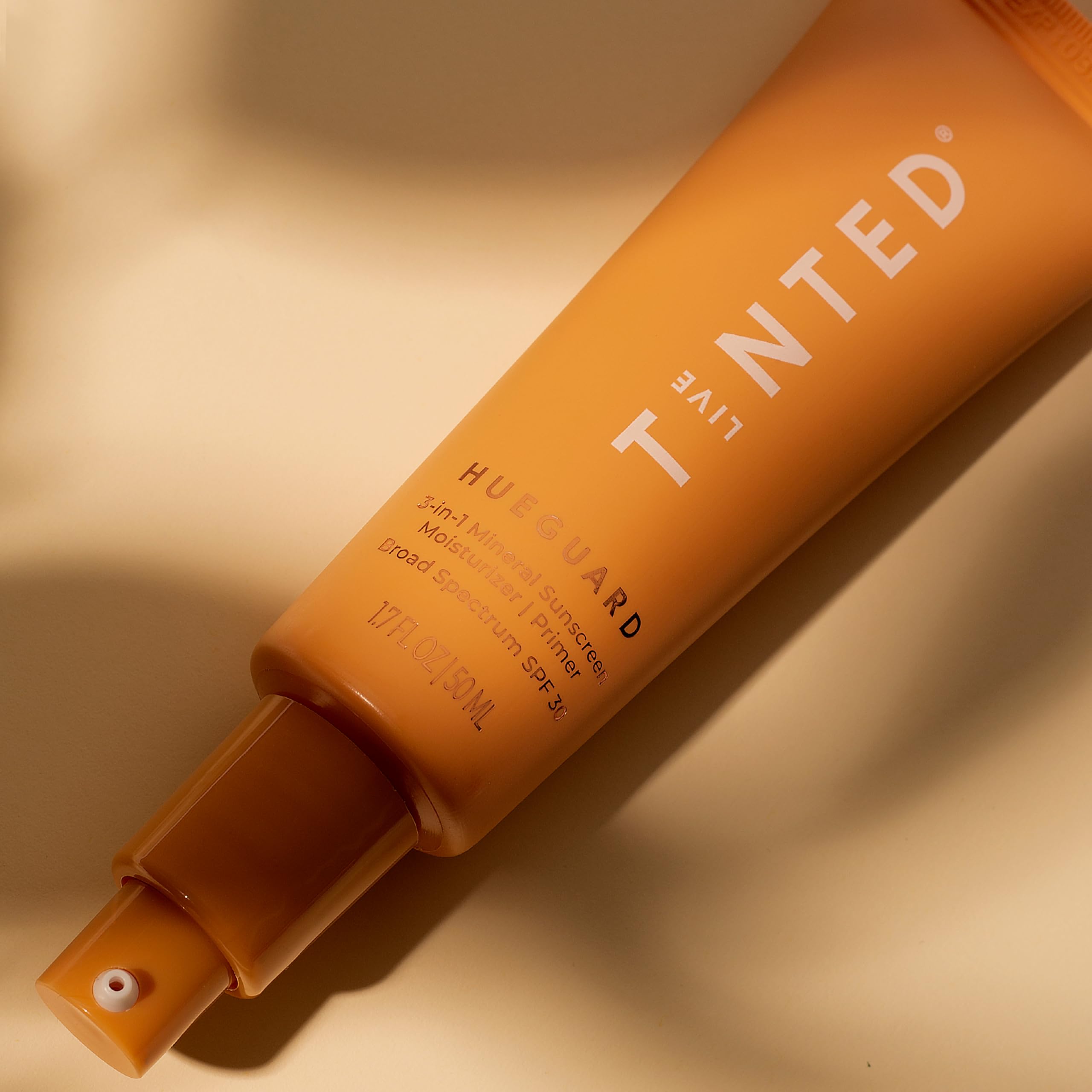Applying Hueguard on neck demonstrates versatile 3-in-1 use.