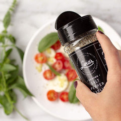 Livia’s Seasoning dispensed on chicken enhances savory aroma and moisture.