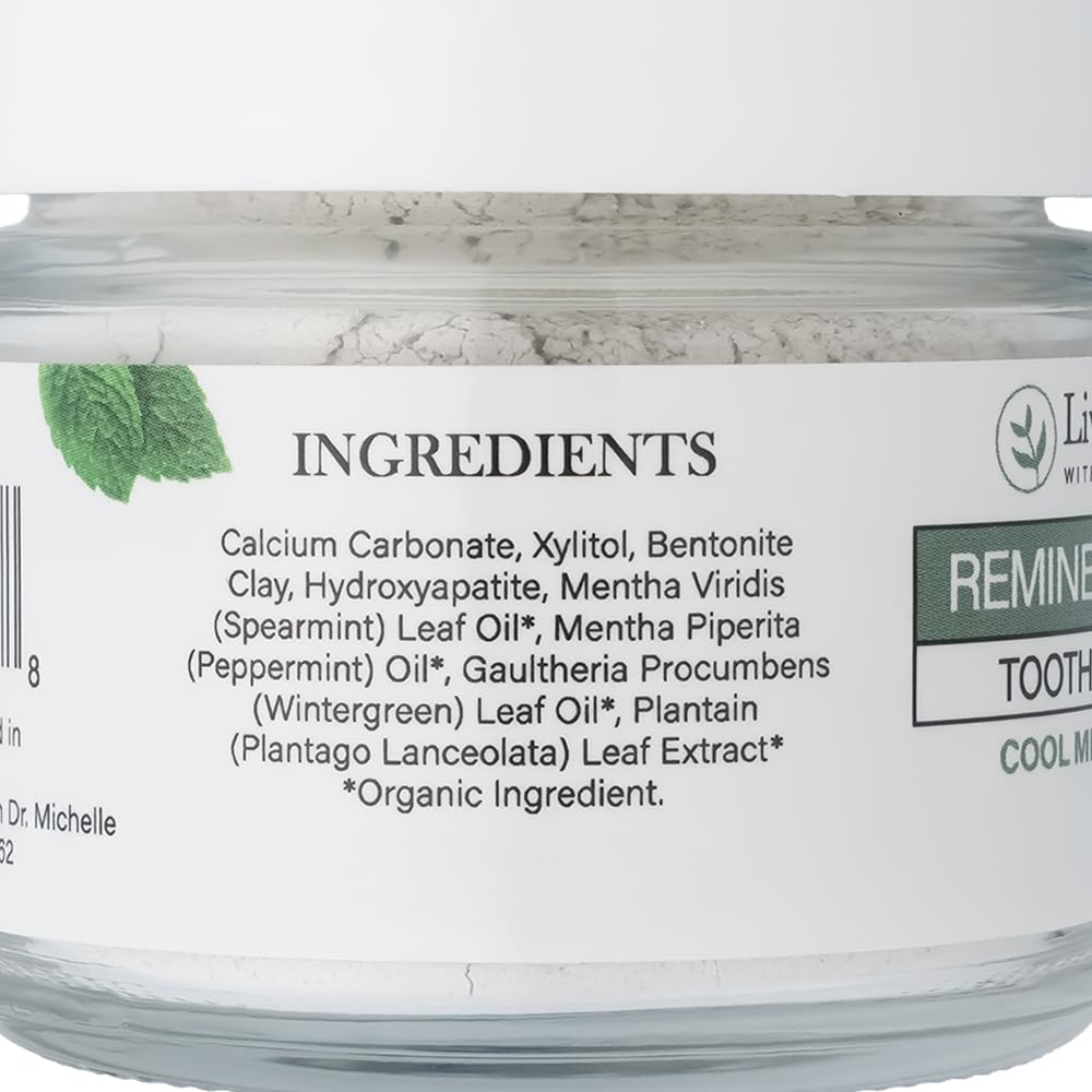 Scoop of Living Well with Dr. Michelle Remineralizing Tooth Powder ready for daily brushing.