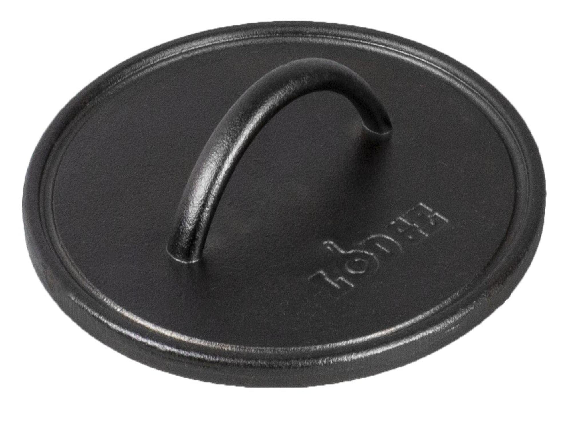 Lodge pre-seasoned round cast iron press close-up of the spiral handle for safe, comfortable grilling.
