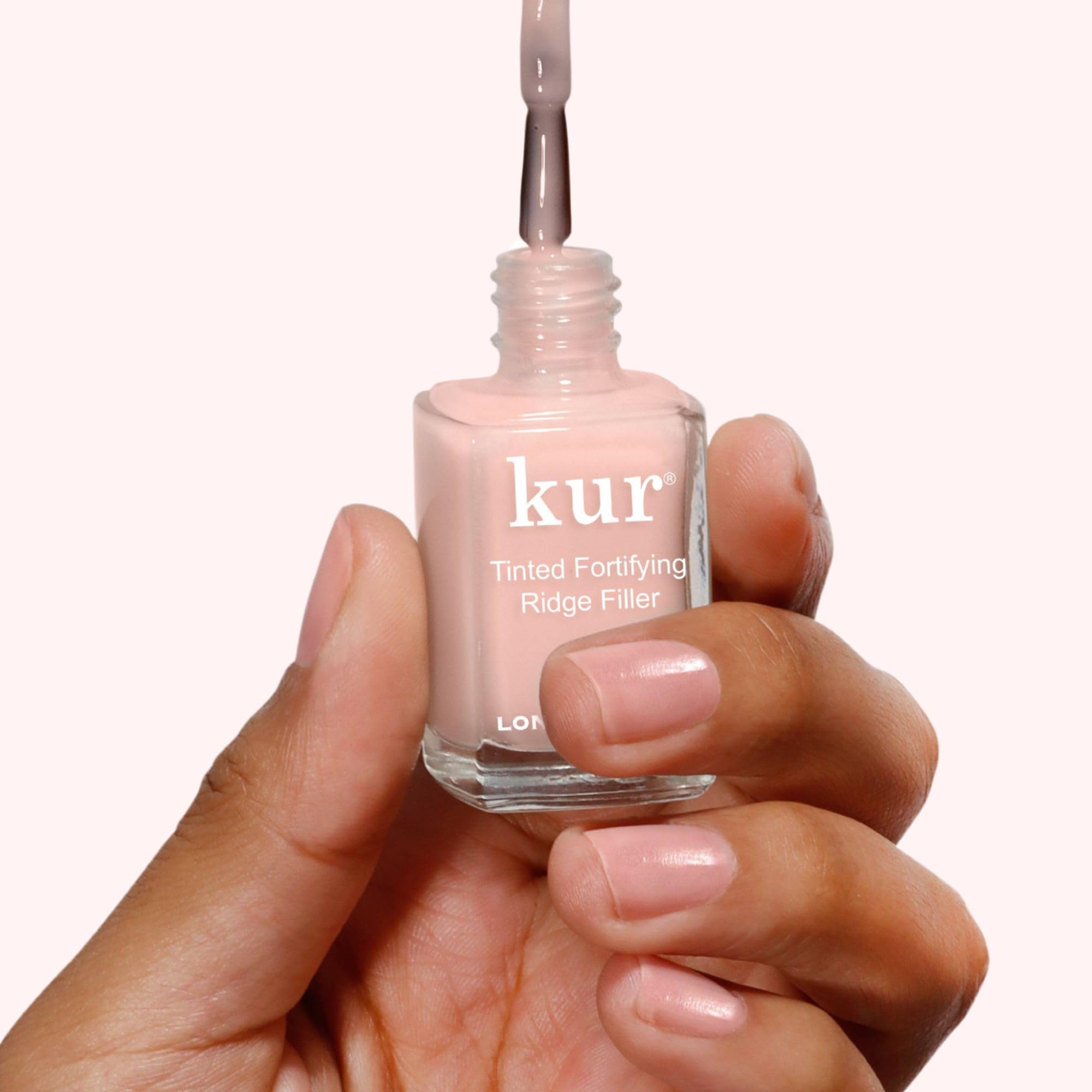 LONDONTOWN Kur Nail Ridge Filler nail swatch in petal pink with sheer tint