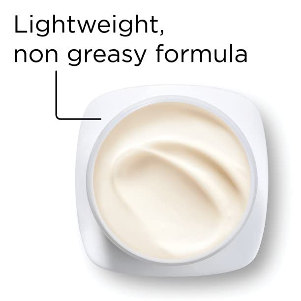 Product packaging on bathroom shelf with soft lighting.