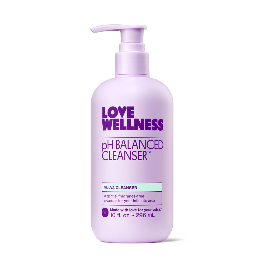 Love Wellness pH Balancing Cleanser bottle on bathroom shelf, fragrance-free and gentle for sensitive skin.