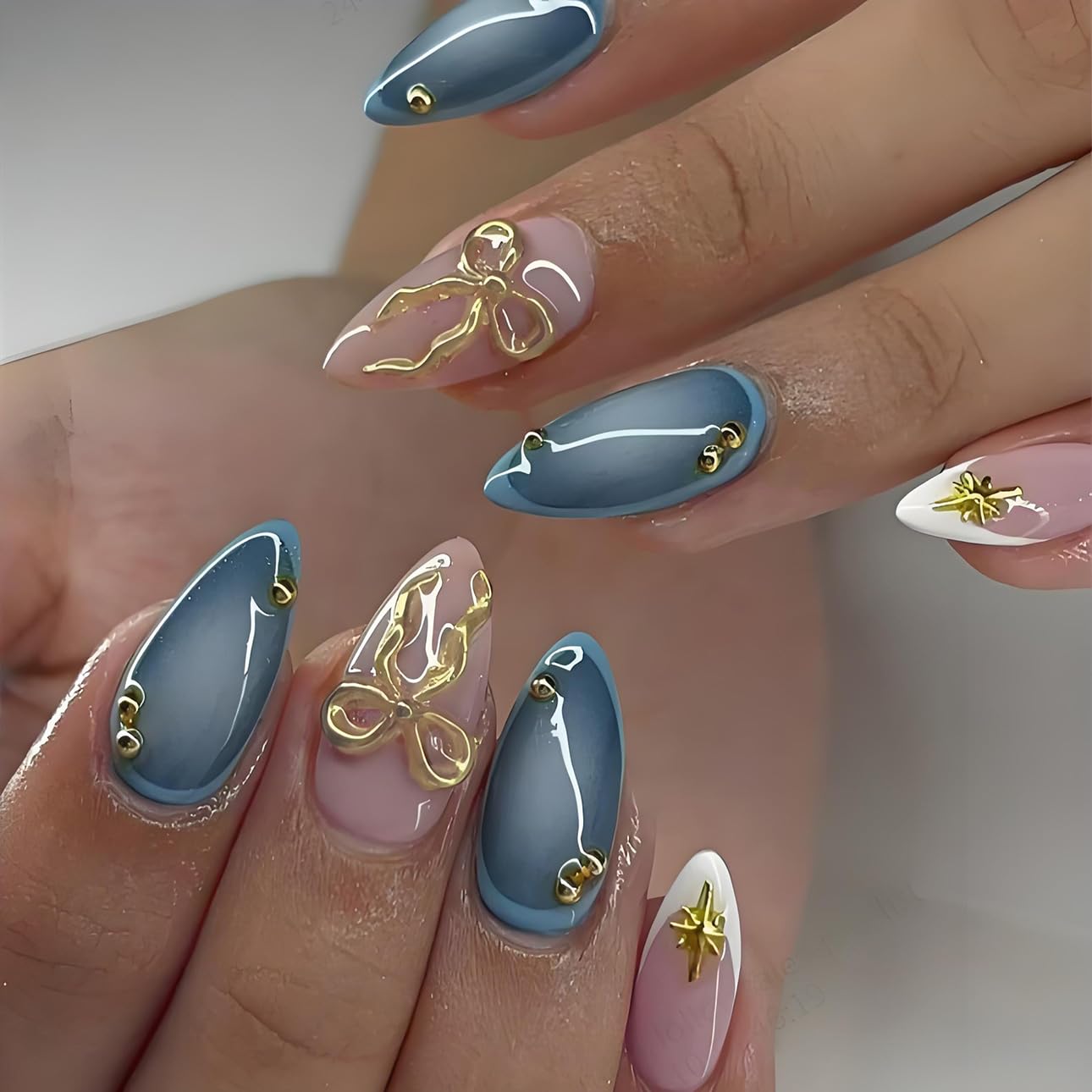 LPOODDNU 3D gold bow nails in almond shape for glamorous at-home styling