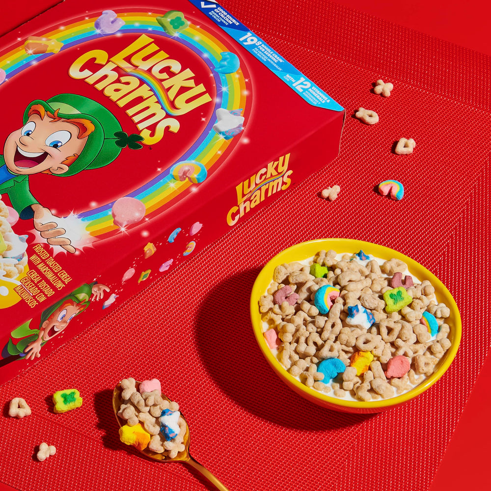 Cereal with milk and marshmallows drifting in a bowl.