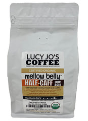 Lucy Jo's Coffee half-caff ground bag highlighting low acid, smooth flavor for all-day sipping