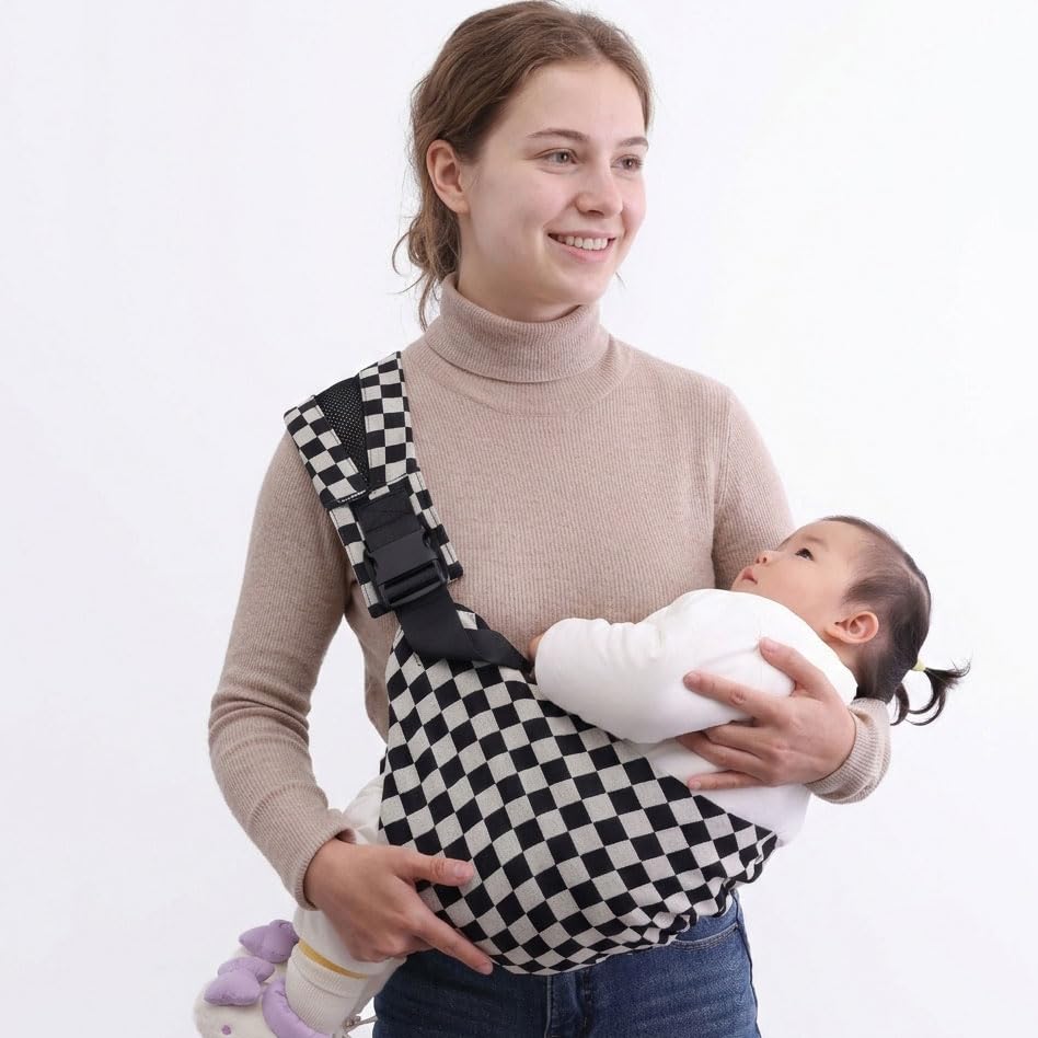 Baby portrait in Lujifo sling demonstrating close, calm cuddle.