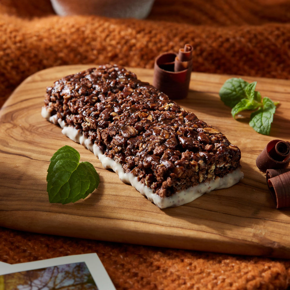 LUNA Bar Chocolate Peppermint Stick cross-section reveals creamy center and oats.