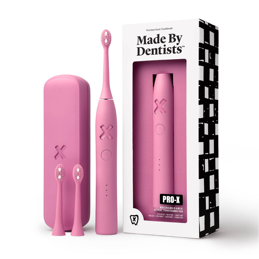 Made by Dentists PRO-X toothbrush front view with pink handle for comfortable daily use.