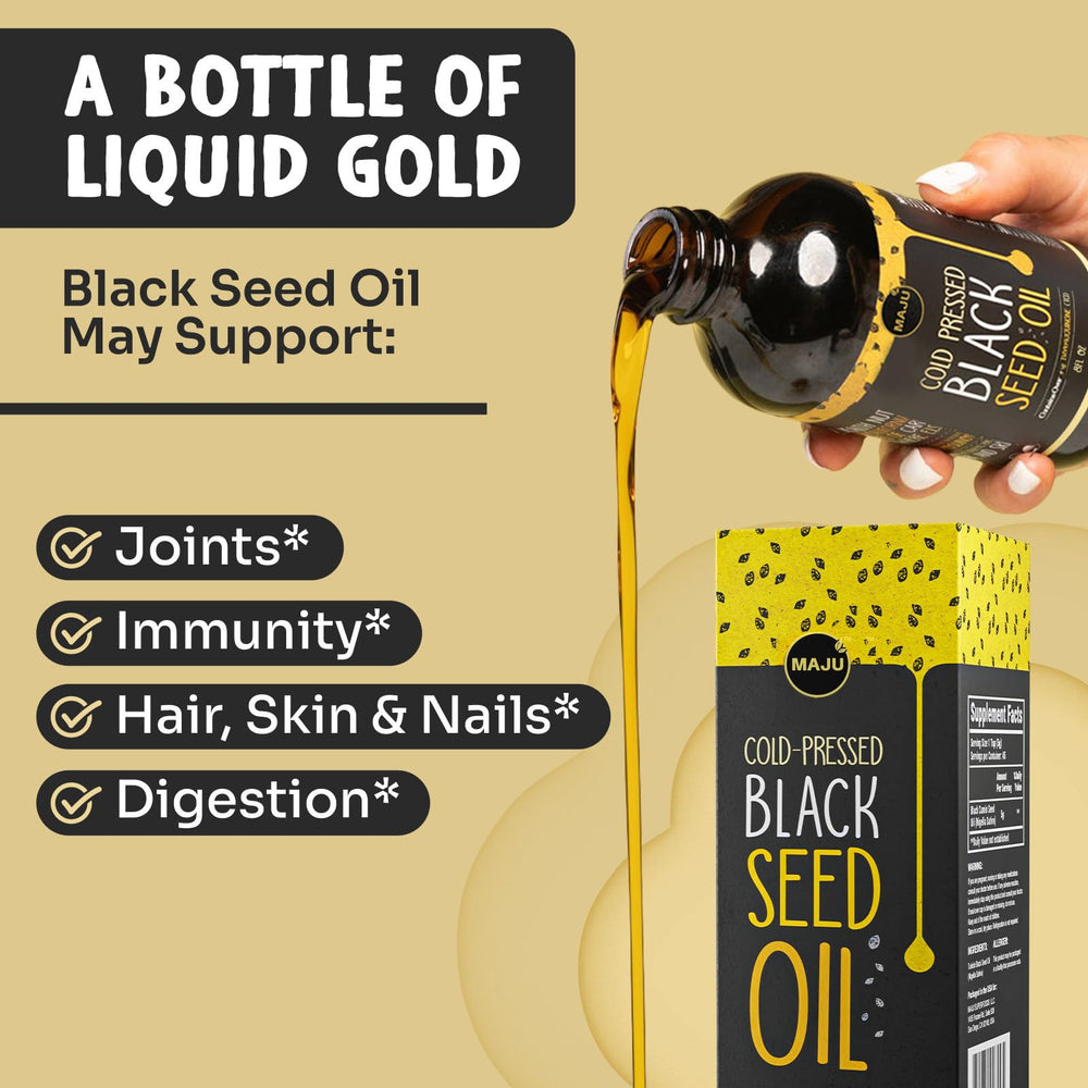 MAJU Black Seed Oil drops on a spoon for daily ritual.