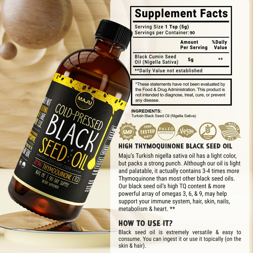 Drops of MAJU Black Seed Oil on salad illustrate easy daily usage.