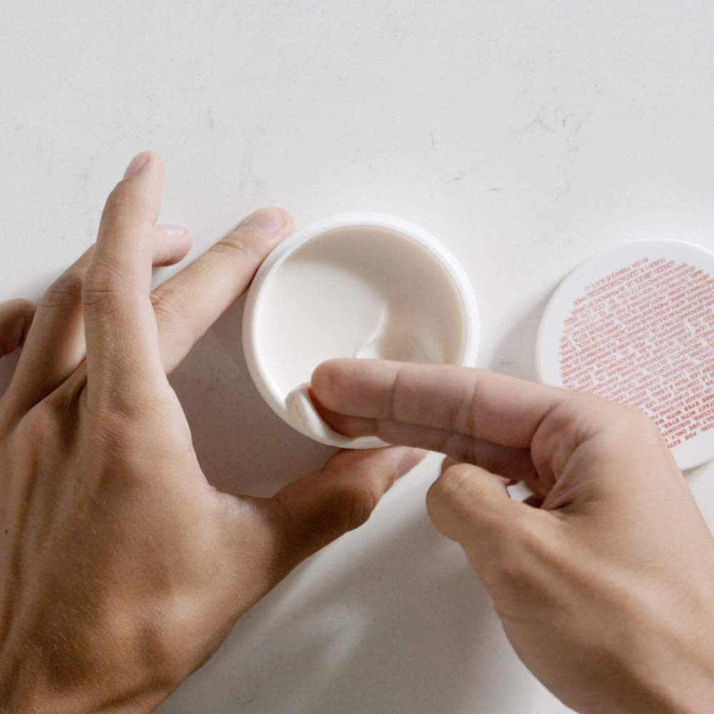 MALIN+GOETZ Hair Pomade beeswax detail emphasizes natural hold.