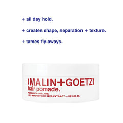 MALIN+GOETZ Hair Pomade hands applying for tamed flyaways and controlled texture.