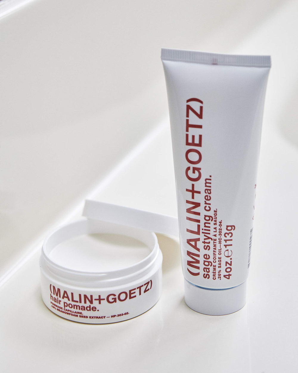 MALIN+GOETZ Hair Pomade packaging box display shows cruelty-free branding.
