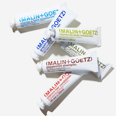 Travel kit packaging of MALIN+GOETZ in recyclable aluminum tubes.